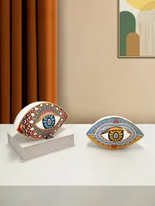 Detailed view of ceramic evil eye ornaments with vibrant mandala patterns for desk decor