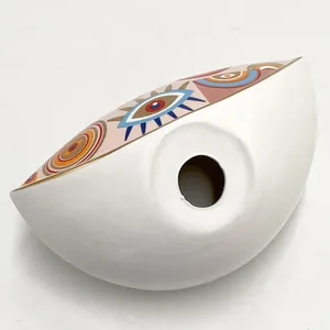 Detail of Nordic ceramic evil eye decor with colorful patterns and a center opening