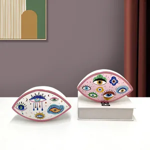 Detail of Nordic gold-rimmed ceramic trays with Evil Eye art in a stylized home setting