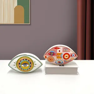 Detail of Nordic evil eye ceramic ornaments with mandala art and gold-rimmed finish