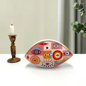 Detail of hand-painted gold rim on ceramic evil eye decorative tray with pop art patterns