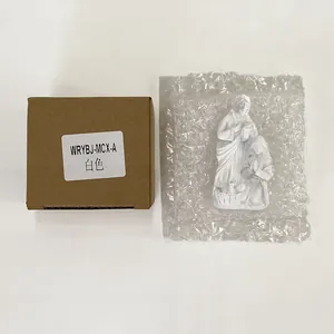Detailed view of holy family resin figurines in protective cardboard packaging box