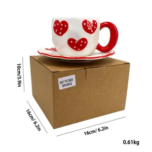 Detail of red heart pattern ceramic coffee cup and saucer with dimensions on box