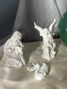 Vista dettagliata delle statuine del presepe in resina bianca con Maria e l'angelo