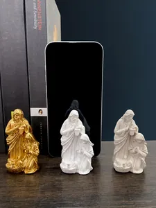 Detailed comparison of Holy Family figurines in gold, white, and cream resin finishes