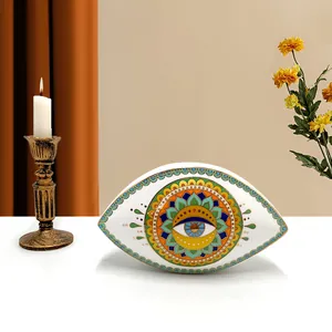 Detailed view of Nordic ceramic evil eye ornament with gold rim and mandala pattern