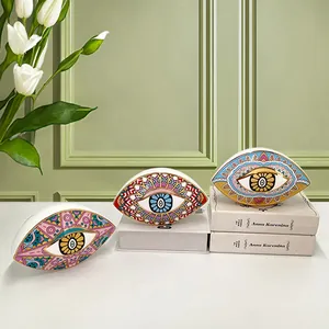 Three-piece ceramic evil eye ornaments with gold-rimmed hand-painted folk art details