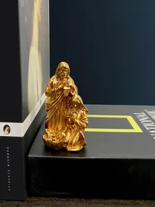 Close-up of golden resin Holy Family statue depicting Saint Joseph, Mary, and Baby Jesus