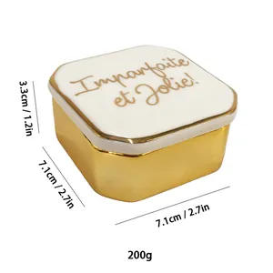 Golden ceramic jewelry box with white lid featuring Imparfaite et Jolie French quote