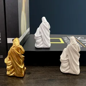 Three Mexican family figurines in gold, pink and white resin for home entrance decor
