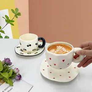 Handcrafted ceramic coffee cup and saucer set with black cherry and red heart patterns