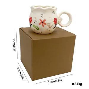 Detail view of floral ceramic mug with wavy edge and dimensions on corrugated packaging box