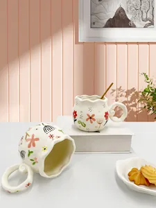 Detail of floral ceramic mug with wavy rim and unique ring handle for afternoon tea