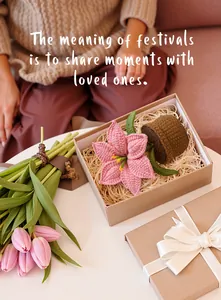 Detailed view of handmade pink lily crochet plant in a brown pot inside a gift box