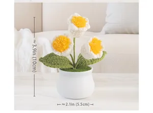 Detail showing dimensions of a handmade crochet forget-me-not flower in a ceramic pot