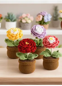 Close-up of colorful handmade crochet peony flowers in knitted pots on a wooden table