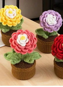 Detail of four colorful handmade crochet ranunculus flower pots on a wooden surface