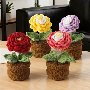 Handmade crochet potted buttercup flowers set in four colors on a wooden table