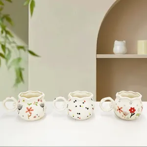 Handcrafted ceramic flower coffee mugs with scalloped edges and floral patterns