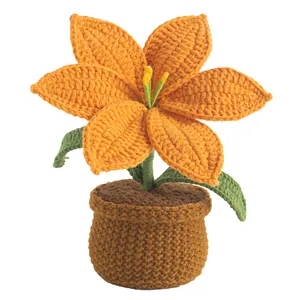 Handmade crochet orange lily flower in a brown potted base for desk decoration