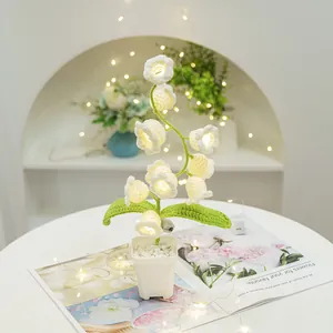 Handmade Lily of the Valley crochet night light in a white pot with warm LED lighting