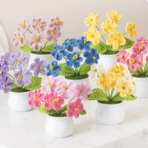 Handmade crochet forget-me-not potted plants set in colorful yarn for home decoration