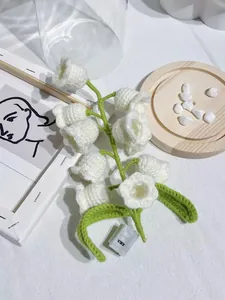 Detail of crochet lily of the valley lamp with white buds and battery box base