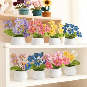 Handmade crochet forget-me-not potted plants in various colors for desktop decoration