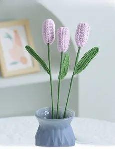 Close-up of hand-knitted lavender tulips in a light blue ceramic vase for home decor