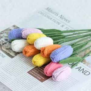 Handmade crochet tulip flower bouquet in assorted colors on vintage newsprint background