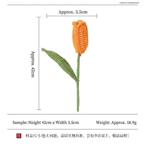 Handmade knitted orange tulip flower with green stem and leaf on white background