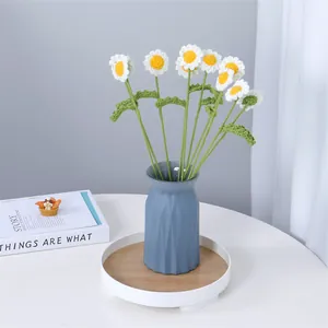 Handmade crocheted daisy bouquet in a modern geometric blue vase for home tabletop decor