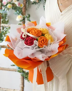 Close-up of handmade crochet rose bouquet with 'Love Is Eternal' ribbon detail