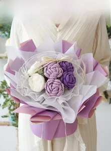 Handcrafted crochet rose bouquet with purple roses and wave edge mesh packaging