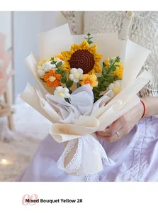 Detail of hand-knitted crochet bouquet with sunflower and daisies in lace-trimmed packaging