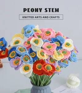 Macro detail of colorful hand-knitted peony bouquet in a textured grey vase decor
