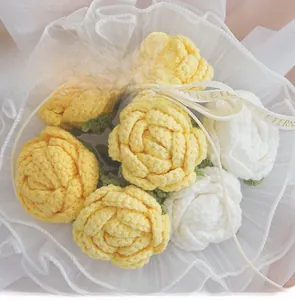 Detailed knit texture of handmade yellow and white crochet roses on lace background