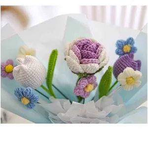 Detail of hand-knitted flower bouquet with crochet tulips and roses in gift wrapping