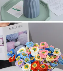 Detail of colorful hand-knitted crochet poppy bouquet with blue ceramic vase and green tray