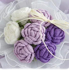 Detailed close-up of handmade crochet roses with gauze wrap and LOVE IS ETERNAL ribbon