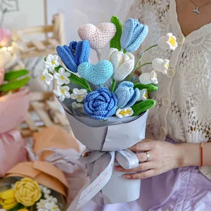 Handmade crochet bouquet with blue roses and heart charm in elegant grey gift wrapping