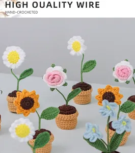 Detail of hand-crocheted mini potted plants with sunflowers and roses made of high-quality yarn