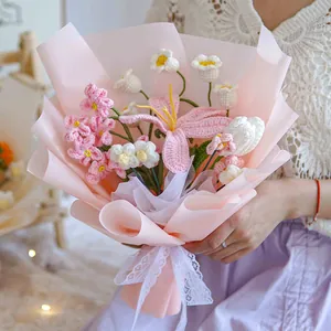 Handmade knitted flower bouquet with lilies and daisies in romantic gift wrap