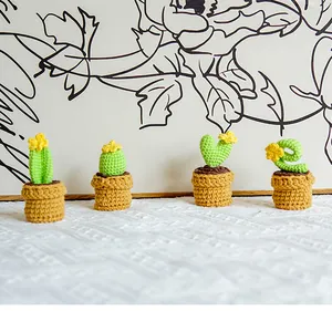 Set of four handmade crochet cactus mini potted plants with small yellow flower details