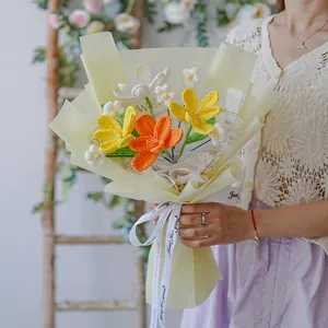 Handmade crochet flower bouquet in yellow and white tones with gift wrap and ribbon