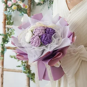 Handmade crochet rose bouquet with purple and white wool flowers in elegant packaging