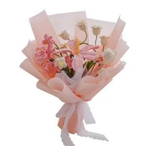 Hand-knitted bouquet with pink lily, lily of the valley, and elegant lace ribbon