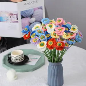 Handmade crochet poppy bouquet with colorful flowers in a blue wave vase decor