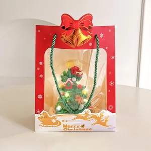 Handmade knitted Christmas tree gift set in a red festive bag with warm LED fairy lights