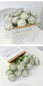Detailed close-up of handmade crochet peony bouquet with artistic grey tinted white petals
